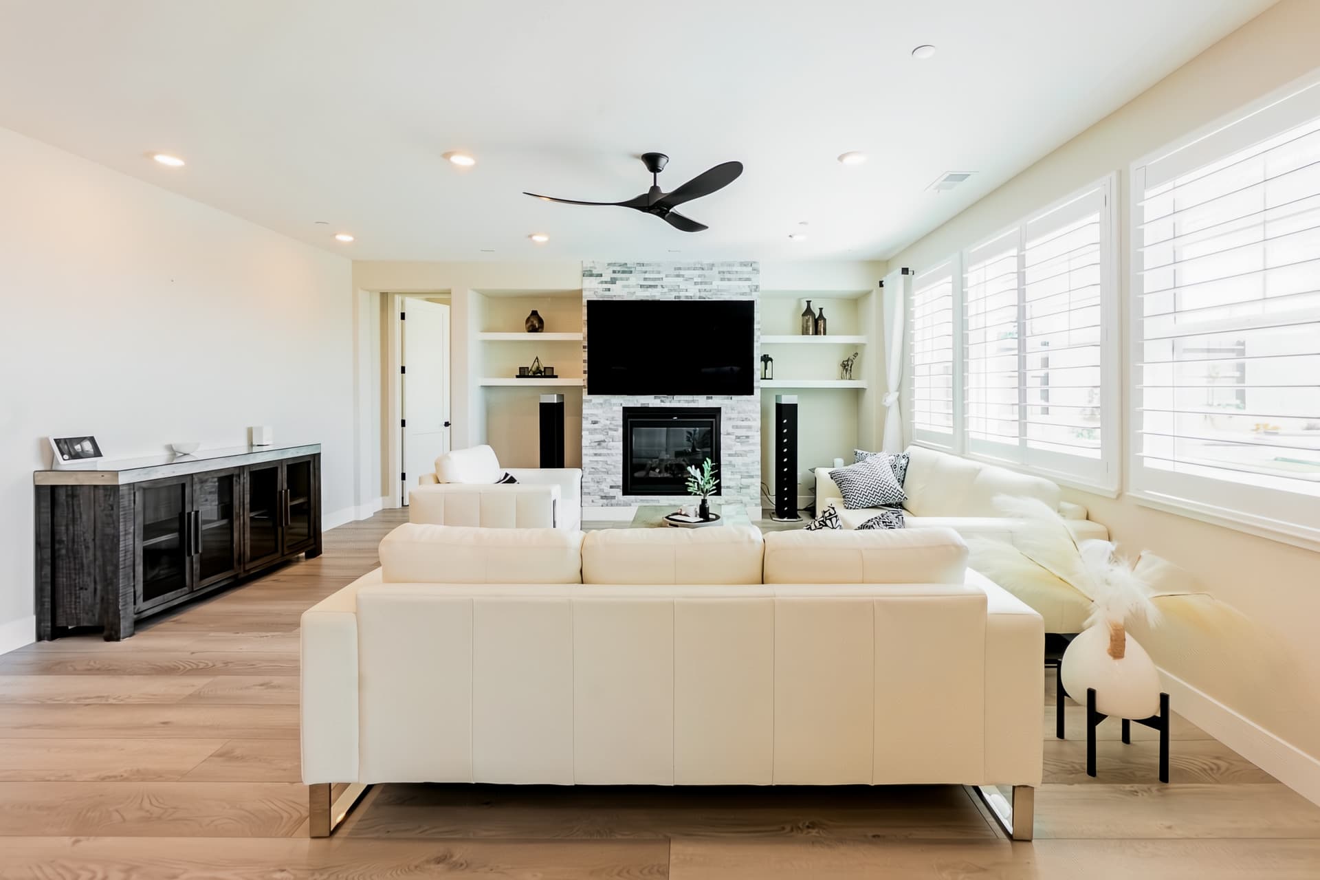 Living room with comfortable couch, flatscreen TV, and natural fireplace